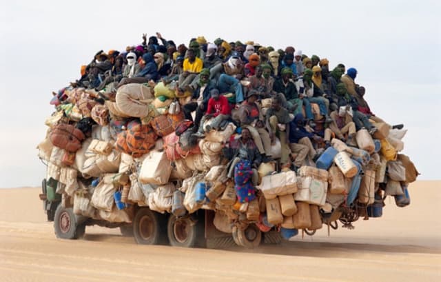 people crowded onto a truck